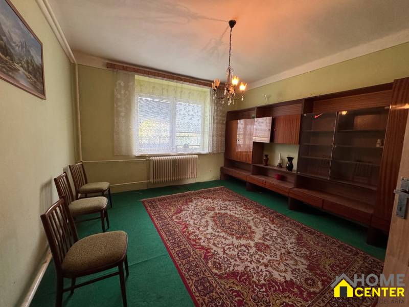 NA PREDAJ!!! Rodinný dom s veľkým pozemkom v obci Vék pri Hurbanove - Obývacia izba s kobercom a nábytkom v Rodinnom dome, jemne osvetlená lustrom.