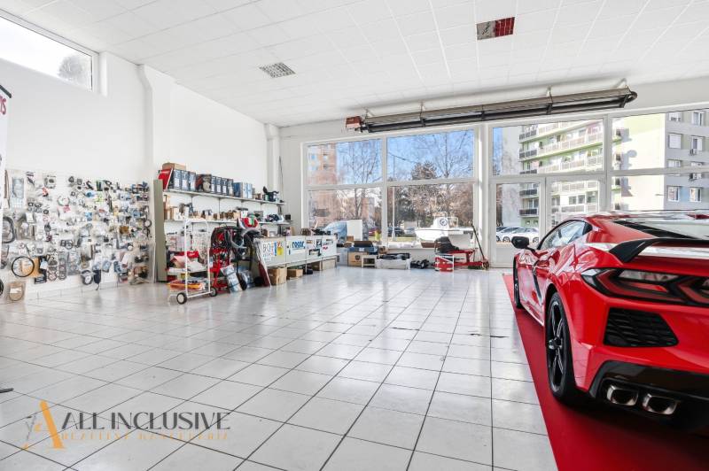 Na prenájom obchodný priestor s kanceláriou, Štúrovo - Autoservisné obchodné priestory so sklom a vystaveným autom na dlažbe, súčiastky na stenách.