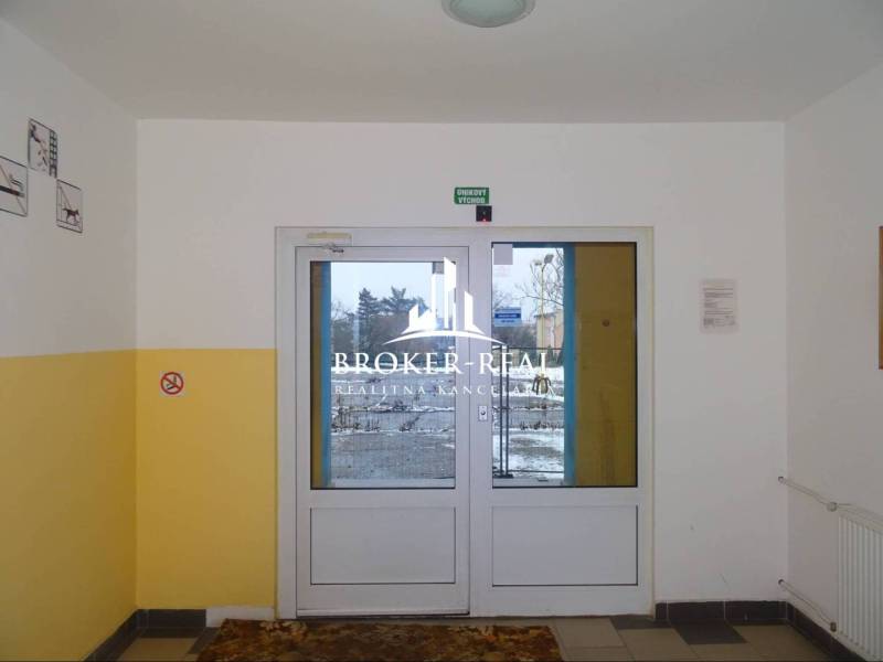 1 - izbový byt Košice, Popradská - Vstupná hala s presklenými dverami, žlté steny, únikový východ v Košiciach - Západ.