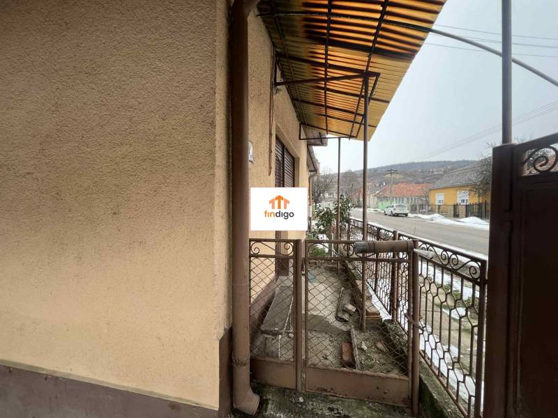 PREDAJ - Rodinný dom v obci Kamenica nad Hronom – len 5 km od Štúrova - Rodinný dom v Kamenici nad Hronom s verandou a kovovým plotom pri vstupnej bráne.