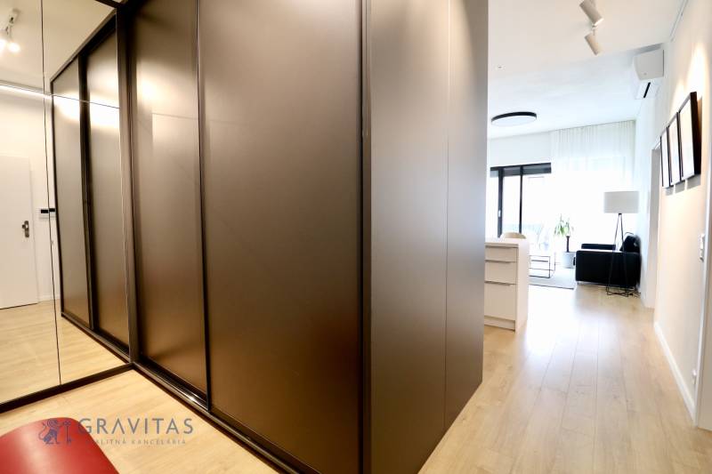 Komfortne vybavený 2-izbový byt v projekte 2 Sýpky - Interiér 2-izbového bytu s podlahou s dreveným dekorom a vstavanou skriňou.