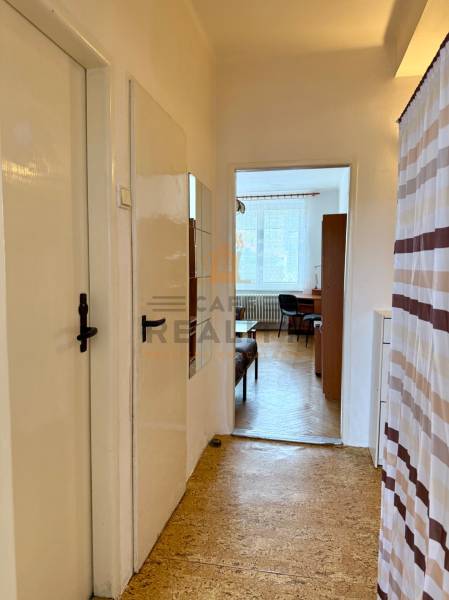 PRENÁJOM 1 izbový byt, 40 M2, Bratislava, Ružinov, Košická ulica, NIVY - Chodba s podlahou s dreveným dekorom a výhľadom do izby v 1-izbovom byte.