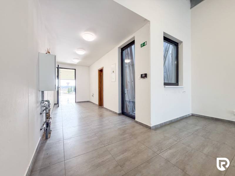 Na prenájom obchodný priestor + sklad, 120m2, FIRMBOX, Trenčín - Interiér obchodného priestoru s dláždenou podlahou a presklenými dverami.