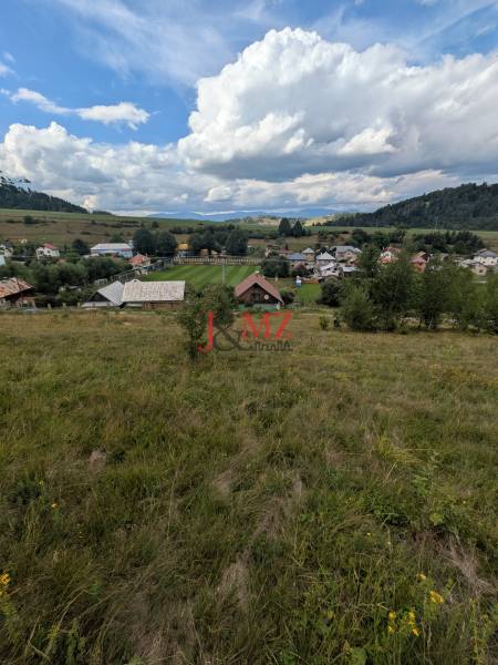 Stavebný pozemok kúsok od lyžiarskych vlekov Čierny Balog - Bexeľ - Zeleň na pozemkoch vhodných pre bývanie v Čiernom Balogu s viditeľnou časťou dediny a oblohou.