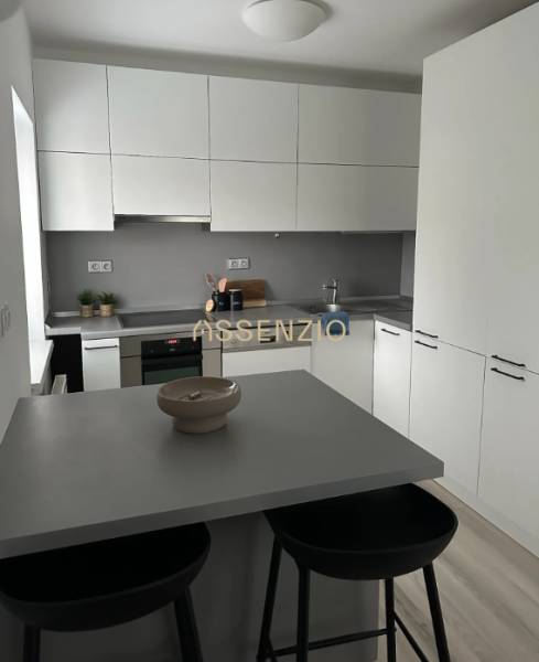 - PRENÁJOM - 2 IZBOVÝ BYT - DOLNÁ UL. - STARÉ MESTO - Kuchyňa v 2-izbovom byte s jednoduchým vybavením a podlahou s dreveným dekorom.