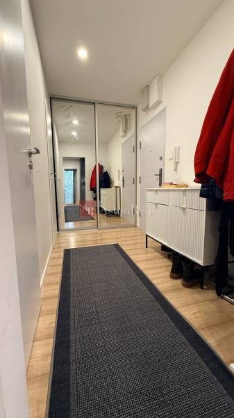 KOMPLETNE prerobený 4i byt s balkónom, 77m2 - ZÁTVOR - Chodba 4-izbového bytu s podlahou v drevenom dekore a veľkým zrkadlom.