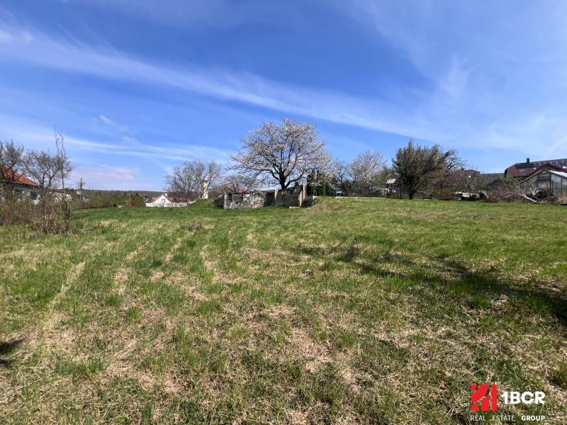 STAVEBNÝ POZEMOK S DUŠOU LEN PÁR MINÚT OD BRATISLAVY V OBCI MARIANKA - Pozemky na bývanie na Budovateľskej ulici v Marianke, obklopené zeleňou a stromami.