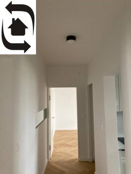 Predaj 2 izbového bytu, Drotárska cesta, Bratislava - Chodba v 2-izbovom byte s podlahou s dreveným dekorom a bielymi stenami.