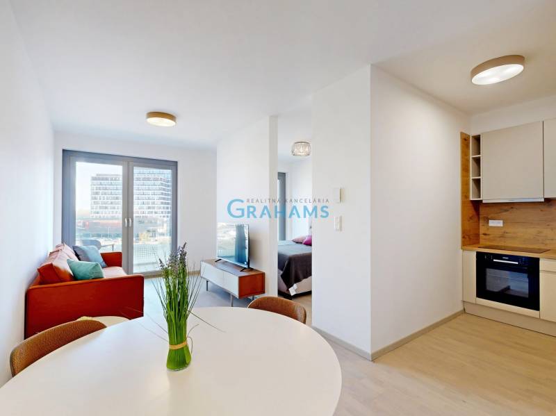 Nový, ešte neobývaný 1,5-izbový byt, parkovanie, Metropolis, Bottova - 2-izbový byt s podlahou s dreveným dekorom, jedálenským stolom a pohovkou.