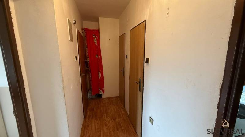 Na predaj 3i byt Pukanec - Chodba v 3-izbovom byte s podlahou s dreveným dekorom a bielymi stenami.