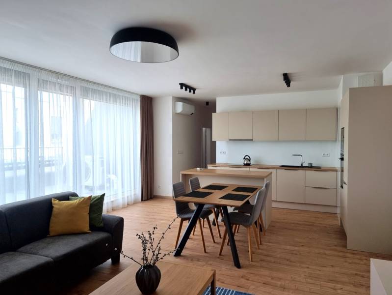PRENÁJOM - 3 izbový byt Nitra – Piesková ulica, RIVIERA NITRA - Obývacia a kuchynská časť v 3-izbovom byte s podlahou s dreveným dekorom.