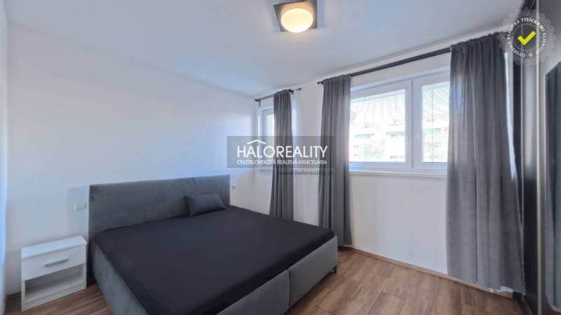 Prenájom, dvojizbový byt Stupava, Cementárenská - NO... - Spálňa s posteľou v 2-izbovom byte, okná s roletami, podlaha s dreveným dekorom.