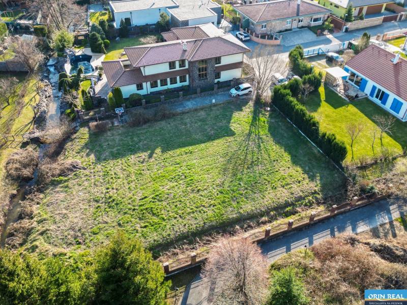  SP V LIMBACHU - 1310 m2 - SO ST.POVOLENÍM A PROJEKTOM V CENE - Na obrázku je pozemok na ulici Družstevná, vhodný na bývanie, obklopený zeleňou.