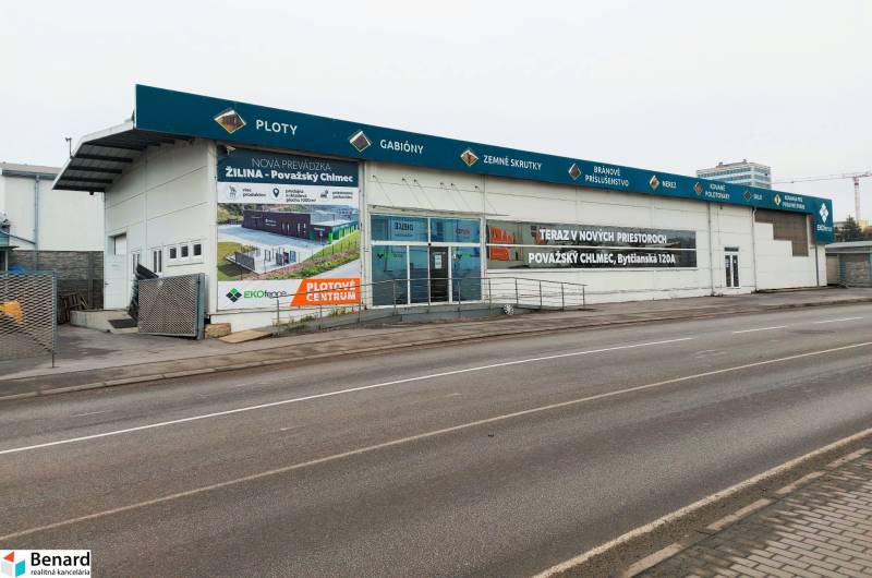 PRENÁJOM: Moderná hala (525 m²) v TOP lokalite Žiliny – Kamenná ul. - Obchodné priestory na Kamennej ulici v Žiline s reklamnými nápismi a prázdnym parkoviskom.