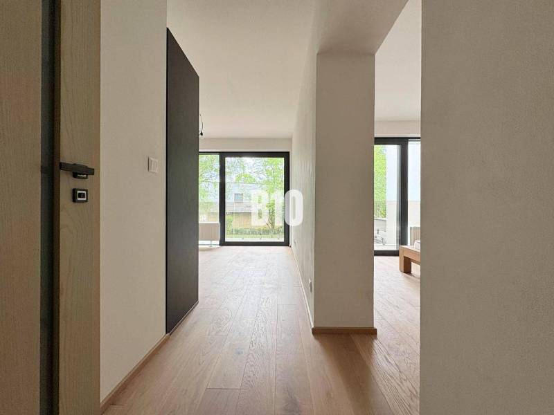 Posledný voľný APARTMÁN na kľúč - Rajecké Teplice - Svetlý interiér dvojizbového bytu s drevenou podlahou a veľkými oknami.