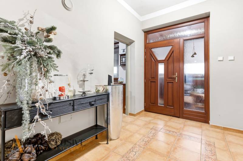 Na predaj zrekonštr.4-izb. rodinný dom, Čečínska Potôň - Vstupná hala v rodinnom dome s drevenými dverami a dekoratívnym nábytkom na podlahe.