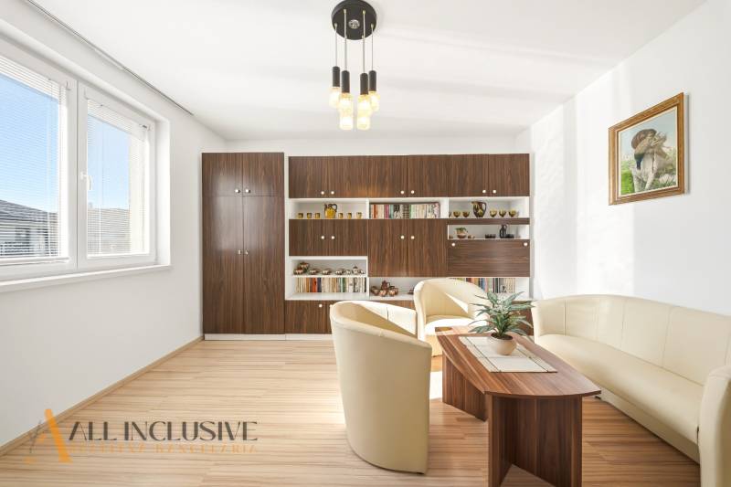 Na predaj 4-izb. rodinný dom s garážou, Kútniky - Obývacia izba v rodinnom dome s podlahou s dreveným dekorom a pohodlným sedením.