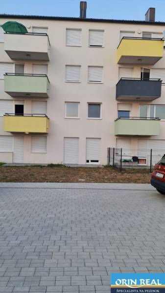 NOVÝ BYT S PREDZAHRADKOU A PARK. STÁTIM - Bytový dom na Nyárfa v Bratislave - Jarovciach s parkoviskom v popredí.