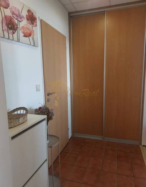 4-izb. byt na ul. Wolkrova, Petržalka, upravený na 2 bytové jednotky - Chodba v 4-izbovom byte s dlažbou, vstavanou skriňou a dekoráciou s kvetinovým motívom.