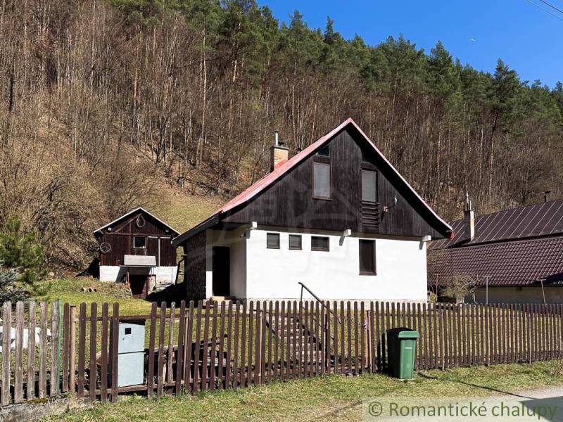 Chalupa - rodinný dom v krásnom prostredí – Moštenica, Banská Bystrica - Chata v Moštenici obklopená lesmi, oplotenie a odpadkový kôš na dvore.
