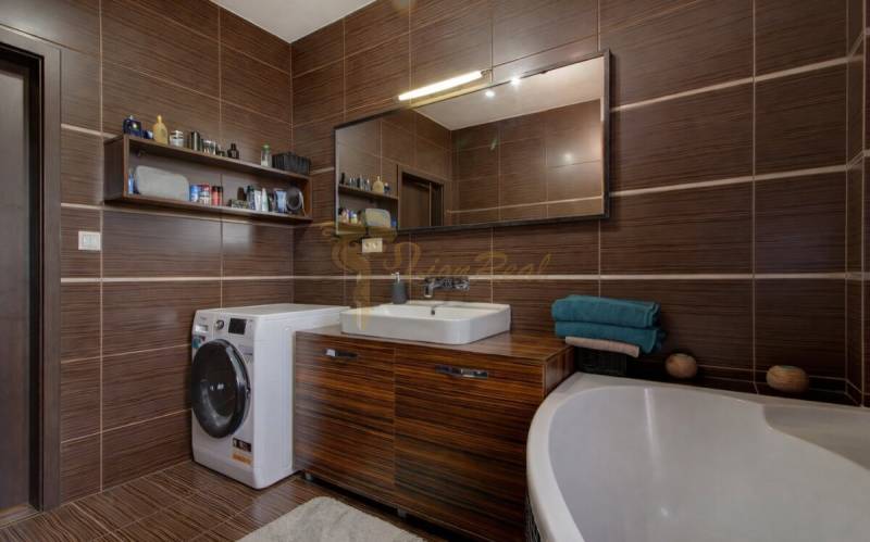 5-izb. byt, Krajinská, Podunajské Biskupice, 2.p./3 - Kúpeľňa v 5 a viac izbovom byte s tmavohnedými obkladačkami a práčkou.