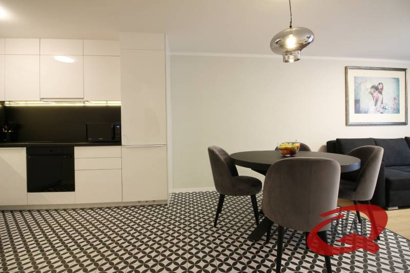 **SKVELÁ INVESTÍCIA**REZIDENCIA OPERA**KÚPELE TURČIANSKE TEPLICE** - Kuchyňa v 2-izbovom byte s jedálenským stolom a geometrickou dlažbou.