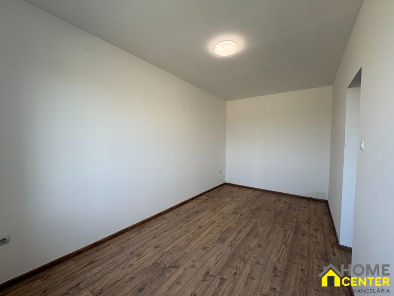 PREDAJ: Rodinný dom po rekonštrukcii /700 m2 pozemok/ Zemianska Olča - Izba s bielymi stenami a podlahou s dreveným dekorom v rodinnom dome.