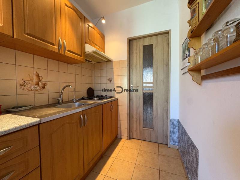 Na predaj: 4 izb.byt + BALKON + ŠATNIK + ŠPAJZA - Kuchyňa v 3-izbovom byte s drevenými skrinkami a keramickým obkladom.