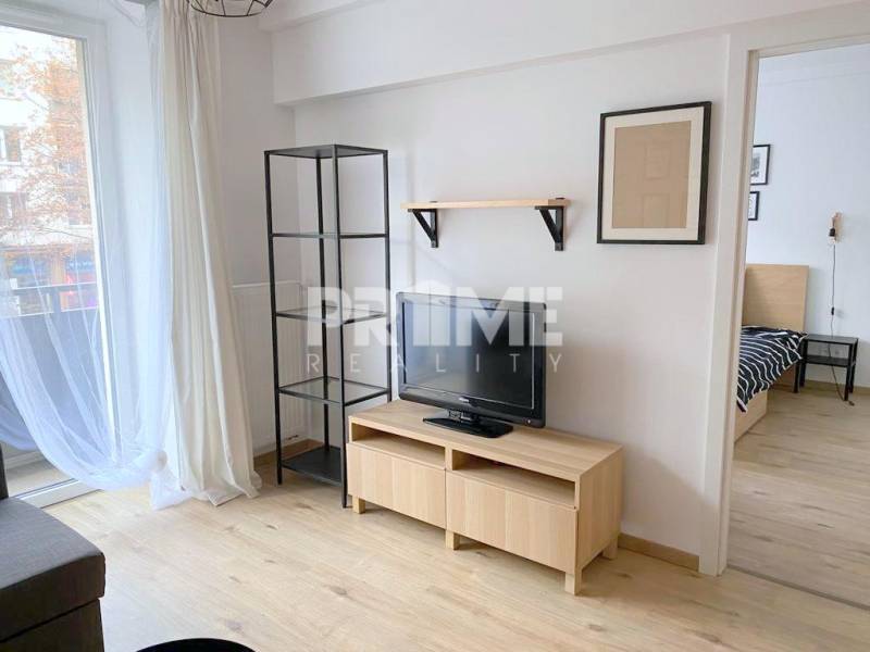 ŠTÝLOVÝ 2i byt, NOVOSTAVBA, BALKÓN, PARKIN, Paričková ulica, NIVY - Obývacia izba na ulici Páričkova, 2-izbový byt s dreveným nábytkom a TV.