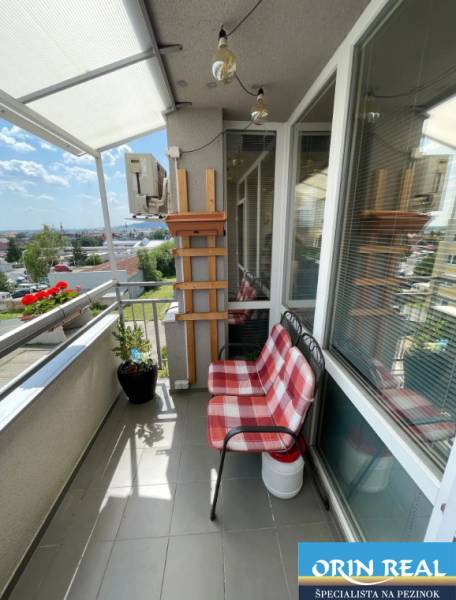 PREDAJ PRIESTRANNÉHO 3 IZB. BYTU NA MUŠKÁTE S GARÁŽOVÝM STÁTIM - Balkón 3-izbového bytu na Silvanovej ulici v Pezinku s posedením a výhľadom na mesto.