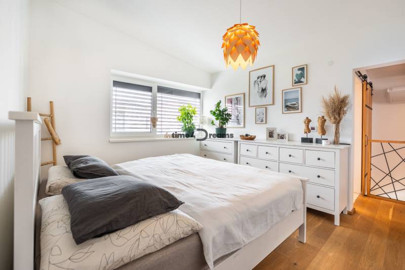 NA PREDAJ Krásny domček v Ivánke pri Nitre - Svetlá spálňa s bielym zariadením, podlaha s dreveným dekorom v rodinnom dome.