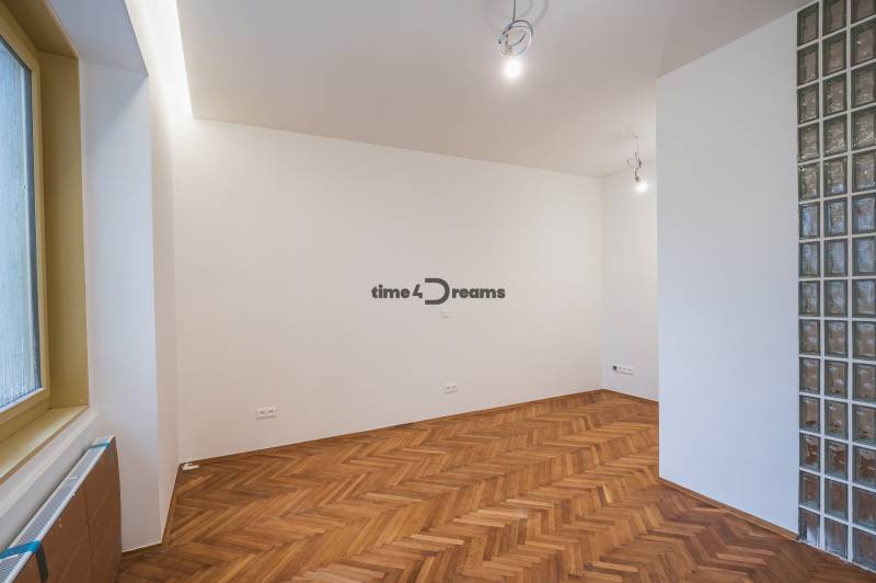 NA PREDAJ štýlový byt v centre Nitry  - Interiér 3-izbového bytu s podlahou s dreveným dekorom, presvetlený priestor, sklenené tehličky.