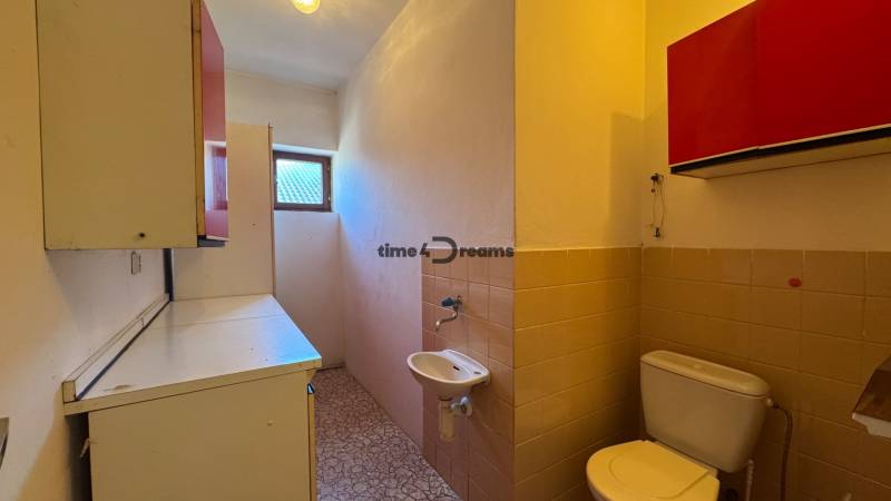 NA PREDAJ 5 izbový rodinný dom v obci Urmince - Topoľčany  - Kúpeľňa v rodinnom dome s umývadlom a WC, svetlo z malého okna.
