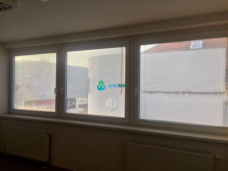 Kancelárie v centre mesta. - Na ulici Hlavná sú veľké okná s roletami, v kancelárie s radiátormi.