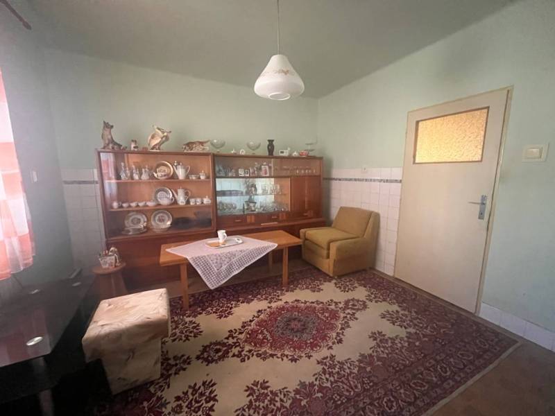 ☎️    0918 846 340    Rodinný dom okamžite obývateľný. - Obývacia izba v Rodinnom dome s vitrínou, kobercom a pohodlným kreslom.