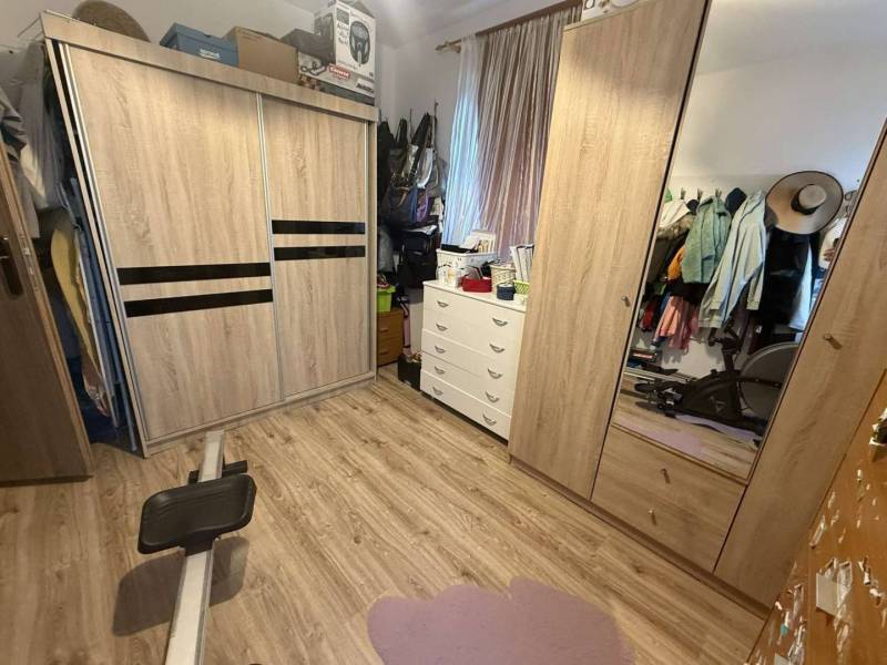 Predaj rodinného domu, Dunajská Streda - Šatník v rodinnom dome s podlahou s dreveným dekorom, šatníkovými skriňami a komodou.