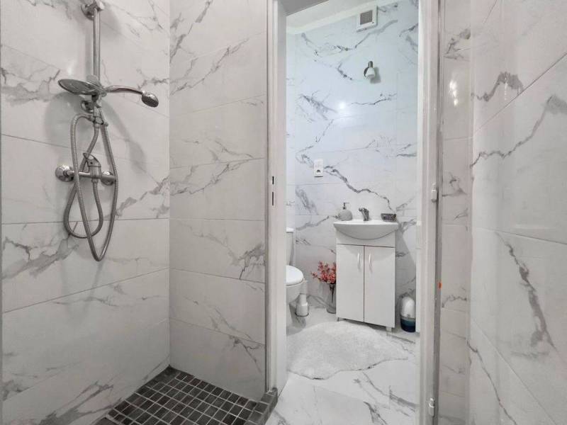 ☎️ 0918197701- PREDAJ - Nebytových priestorov Dunajská Streda - Kúpeľňové obchodné priestory s keramickými obkladmi a sprchovým kútom so sivými detailmi.