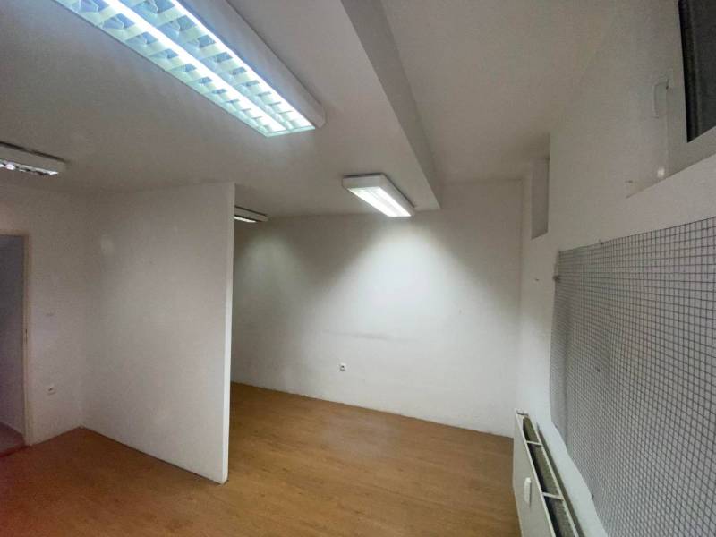 ☎️ 0918197701-Na prenájom menší priestor v suteréne  v srdci  mesta Du - Kancelárie s bielymi stenami a podlahou s dreveným dekorom, osvetlené žiarivkami.