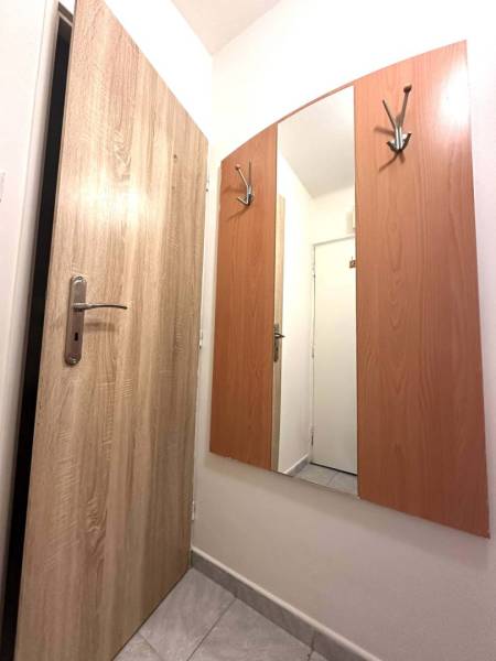REZERVOVANÉ  ☎️ 0918/197 701 Na prenájom garsónka blízkosti centra mes - V Rekreačnom apartmáne vidieť zrkadlo s vešiakmi, podlaha s dreveným dekorom.