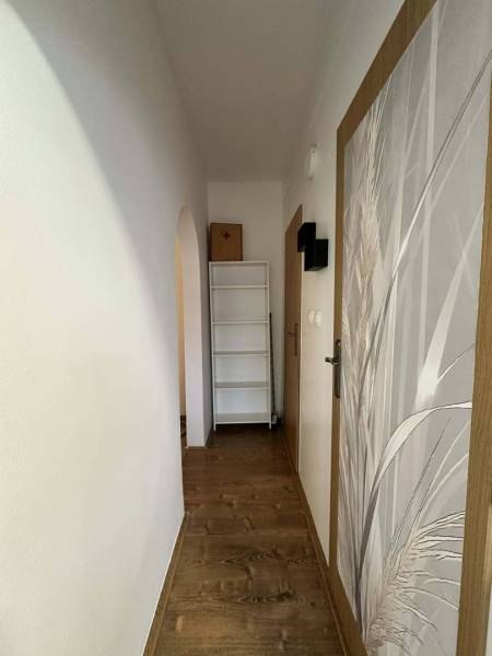 ☎️  0918/197 701  Na prenájom 1 izbový byt s balkónom a pivnicou v mes - Úzka chodba so stenami a podlahou s dreveným dekorom, regálom v 1-izbovom byte.