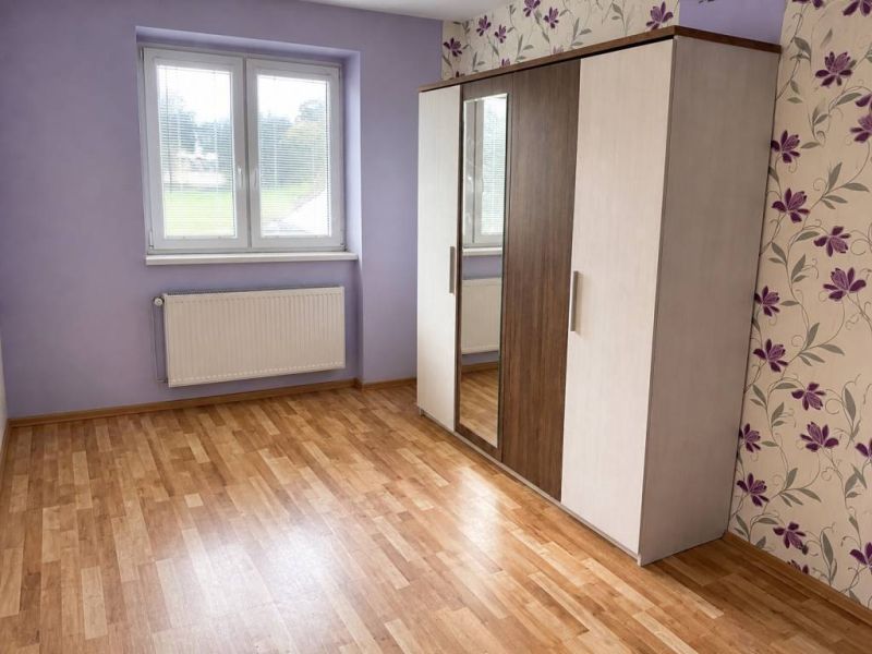 3-izbový byt v Hrnčiarskej Vsi – balkón, pivnica a dostupná cena - Fialovo-biela izba s podlahou s dreveným dekorom a šatníkovou skriňou v 3-izbovom byte.
