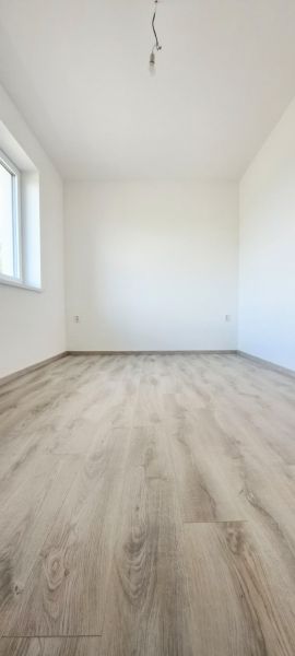 Novostavba pri jazere - 4 izbový rodinný dom v štandarde v obci Selice - Prázdna miestnosť s podlahou s dreveným dekorom v rodinnom dome.