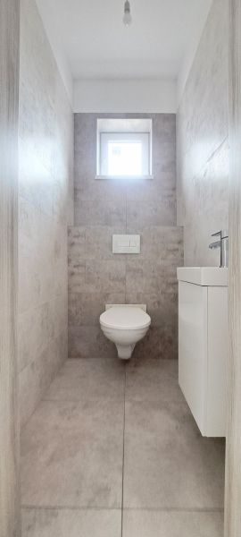 Novostavba pri jazere - 4 izbový rodinný dom v štandarde v obci Selice - Toaleta v rodinnom dome s obkladom a malým oknom.