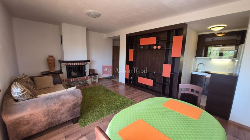 Investičný apartmán Vysoké Tatry - Stará Lesná s balkónom a park.miest - Rekreačný apartmán s podlahou s dreveným dekorom, krbom a kuchynkou, útulný interiér.