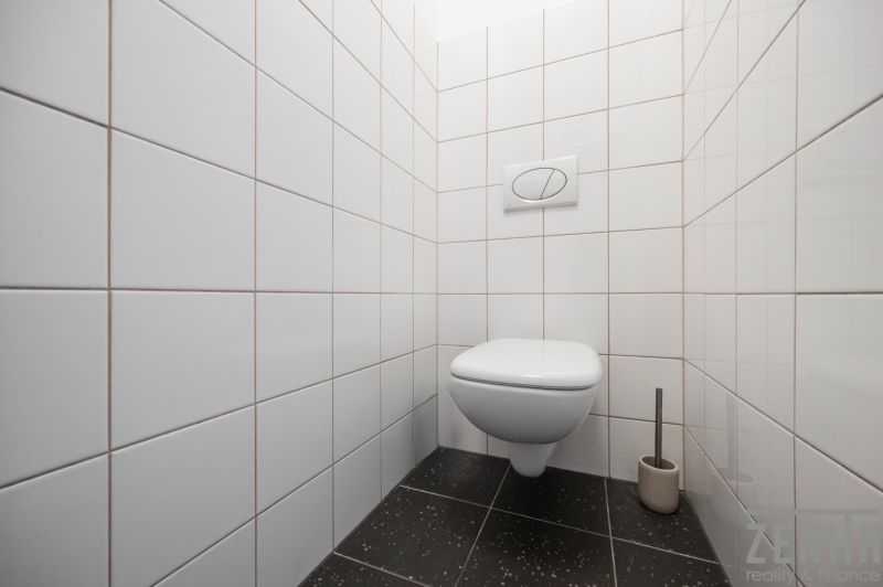 2-izbový byt po rekonštrukcii v Starom Meste na predaj  - Toaleta s bielymi kachličkami a čiernou podlahou v 2-izbovom byte.