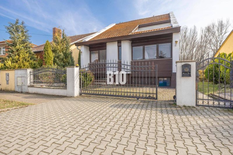 NADČASOVÝ 5-IZBOVÝ RODINNÝ DOM PRI HRÁDZI – HAMULIAKOVO - Rodinný dom na Dunajskej ulici v Hamuliakove s kovovou bránou a záhradou.