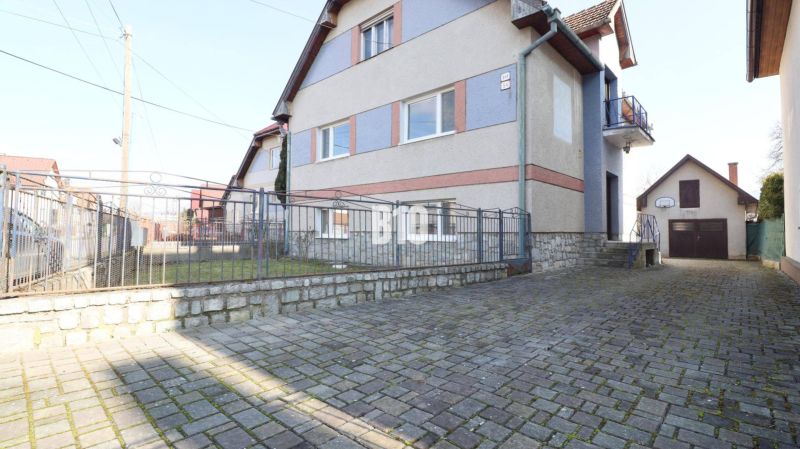 Veľký rodinný dom Turany - Rodinný dom v Turanoch s kamenným plotom a dláždeným dvorom.