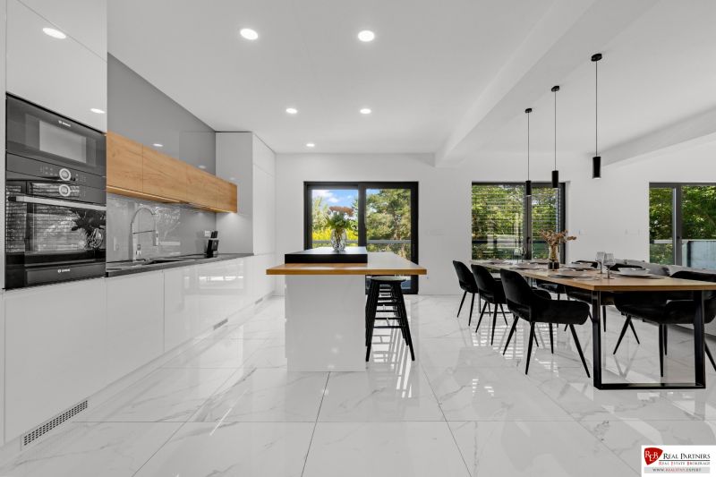 Na predaj nádherný 4 izbový luxusný byt,176 m2 + terasy 55 m2,2 garáž. - Priestranná kuchyňa a jedáleň so štýlovým zariadením v 4-izbovom byte, podlaha s dreveným dekorom.