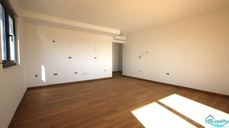 Vodice(HR)-3-izbový byt 81 m2 so záhradou - Svetlá miestnosť s podlahou s dreveným dekorom v rekreačnom apartmáne.