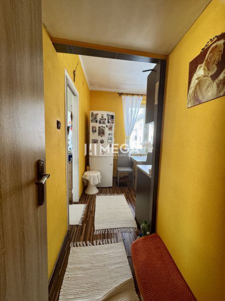 PREDANÉ- 2 izbový byt s balkónom blízko centra mesta Humenné - Chodba 2-izbového bytu so žltými stenami a podlahou s dreveným dekorom.
